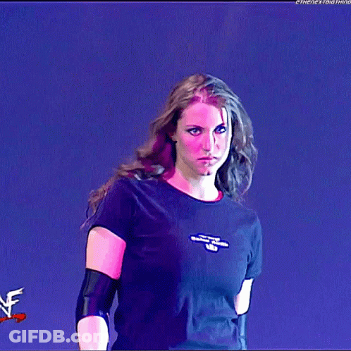 A Woman Wearing A Black T-Shirt With The Word Wrestling On The Front GIF