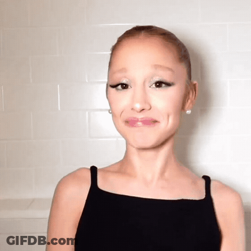 A Woman Wearing A Black Tank Top Making A Funny Face GIF
