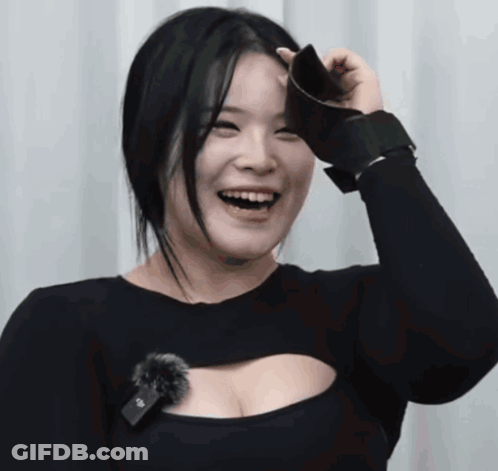 A Woman Wearing A Black Top With A Microphone On It GIF