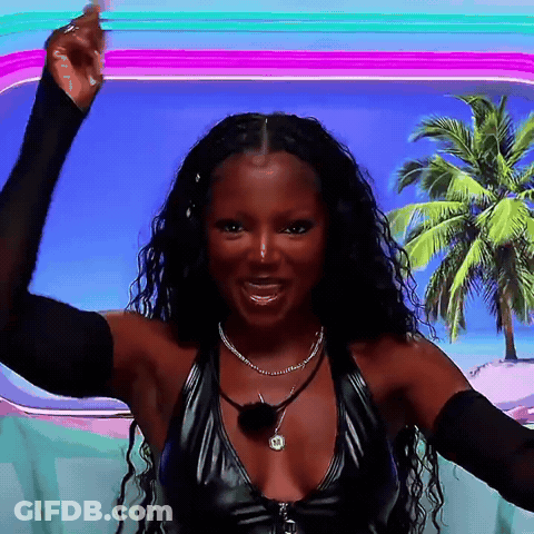A Woman Wearing A Black Top With A Necklace That Says ' A ' On It GIF