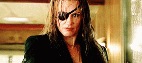 A Woman Wearing A Blindfold And A Bullet Hole In Her Eye GIF