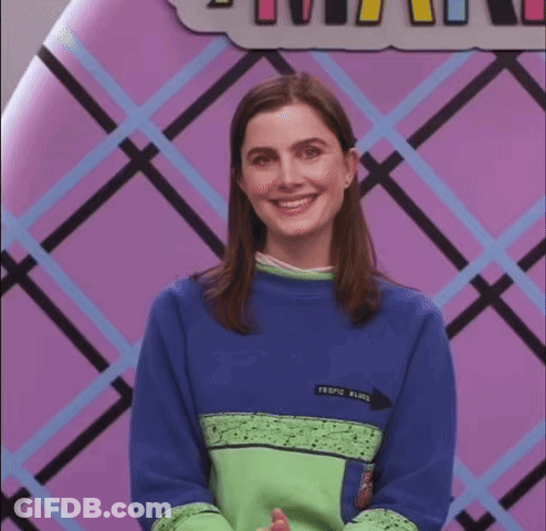 A Woman Wearing A Blue And Green Sweater With The Word Tropic Written On It GIF