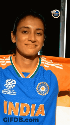 A Woman Wearing A Blue And Orange Jersey That Says India GIF