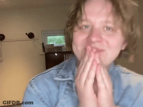 A Woman Wearing A Blue Denim Jacket With The Letter L On It GIF