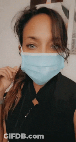 A Woman Wearing A Blue Face Mask With A Black Shirt GIF