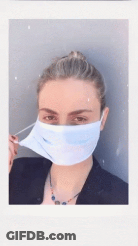 A Woman Wearing A Blue Face Mask With A Bun GIF