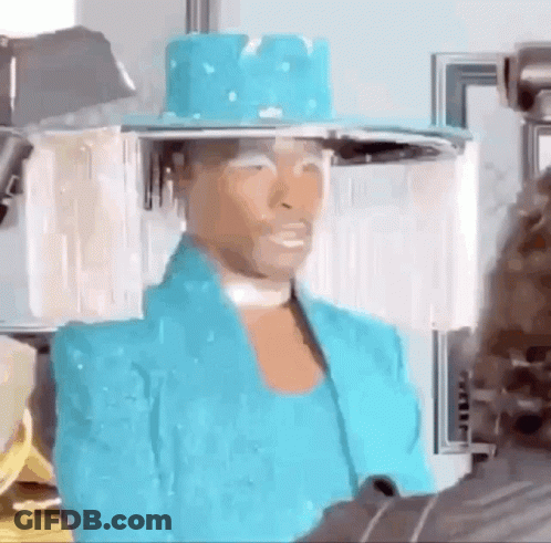 A Woman Wearing A Blue Hat And A Blue Jacket Is Talking To A Man . GIF