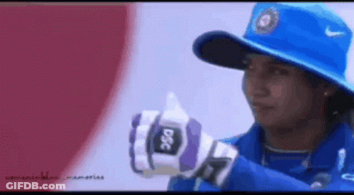 A Woman Wearing A Blue Hat And Gloves With Dsc On Them GIF