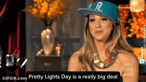 A Woman Wearing A Blue Hat With The Letter R On It Says Pretty Lights Day Is A Really Big Deal GIF