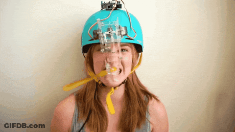 A Woman Wearing A Blue Helmet With A Robotic Device On It GIF