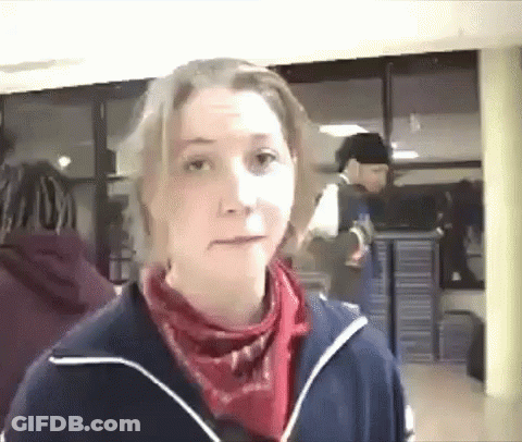 A Woman Wearing A Blue Jacket And A Red Scarf GIF
