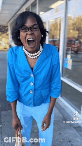 A Woman Wearing A Blue Jacket And Blue Pants Is Screaming GIF