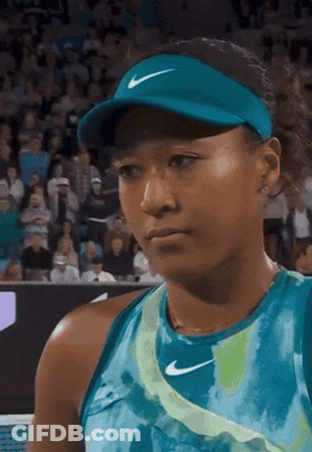 A Woman Wearing A Blue Nike Hat And A Blue Shirt GIF