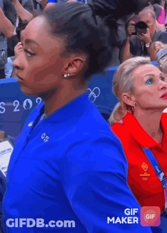A Woman Wearing A Blue Nike Jacket With Usa On It GIF