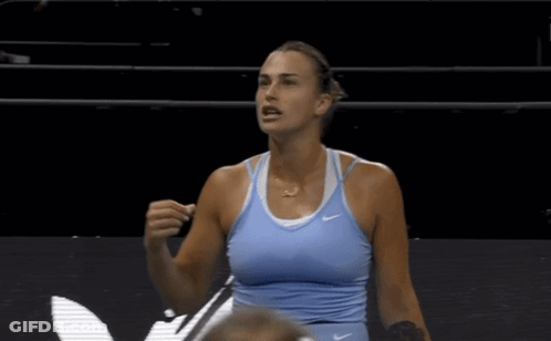 A Woman Wearing A Blue Nike Tank Top Stands On A Court GIF