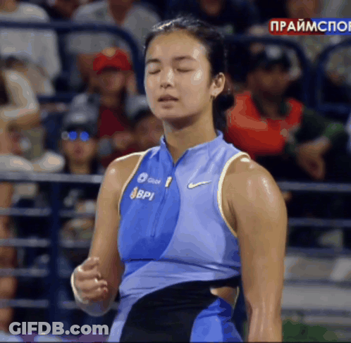 A Woman Wearing A Blue Nike Tank Top With Bpi Written On It GIF