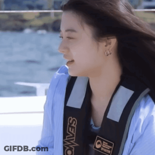 A Woman Wearing A Blue Shirt And A Black Vest That Says Seavest GIF