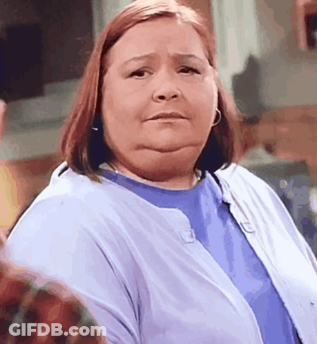 A Woman Wearing A Blue Shirt And A Blue Cardigan GIF