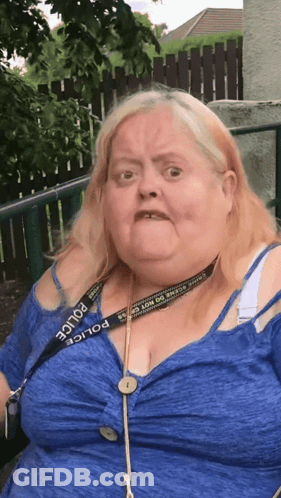 A Woman Wearing A Blue Shirt And A Police Lanyard GIF