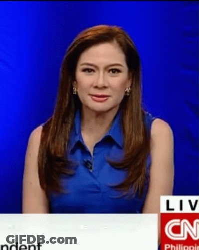 A Woman Wearing A Blue Shirt Is Sitting In Front Of A Cnn Logo GIF