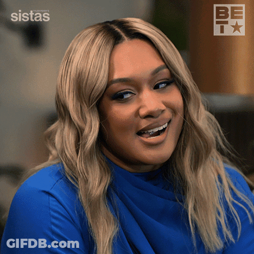 A Woman Wearing A Blue Shirt Is Smiling In Front Of A Be Tv Logo GIF