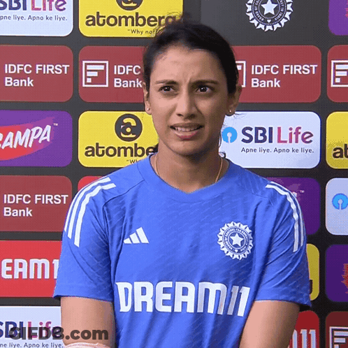 A Woman Wearing A Blue Shirt That Says Dream11 On It GIF