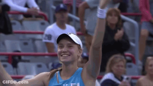 A Woman Wearing A Blue Shirt That Says ' Reebok ' On It GIF