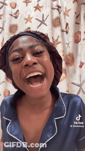 A Woman Wearing A Blue Shirt That Says Thickneyy On It GIF