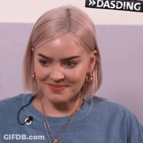 A Woman Wearing A Blue Shirt With A Microphone And A Sign That Says Dasding On It GIF