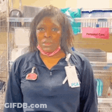 A Woman Wearing A Blue Shirt With A Name Tag That Says Pca On It . GIF