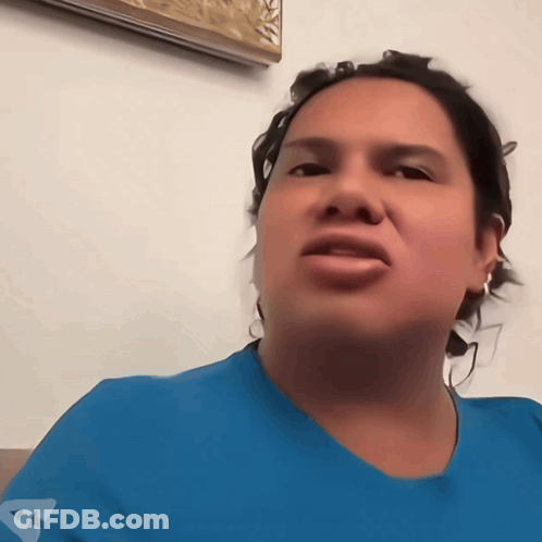 A Woman Wearing A Blue Shirt With The Letter A On The Front GIF
