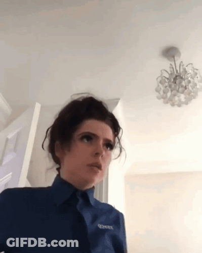 A Woman Wearing A Blue Shirt With The Word Corner On The Front GIF