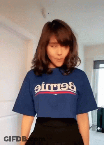 A Woman Wearing A Blue T-Shirt That Says ' Balenciaga ' GIF
