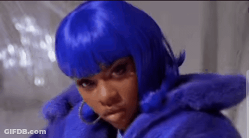A Woman Wearing A Blue Wig And A Blue Fur Coat Is Making A Funny Face . GIF