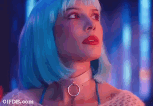 A Woman Wearing A Blue Wig And A Choker Is Looking Up At The Sky . GIF