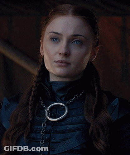 A Woman Wearing A Braided Ponytail And A Chain Around Her Neck . GIF
