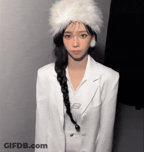 A Woman Wearing A Braided Ponytail And A White Fur Hat GIF