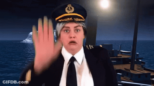 A Woman Wearing A Captain 'S Hat And Tie Is Making A Stop Sign GIF