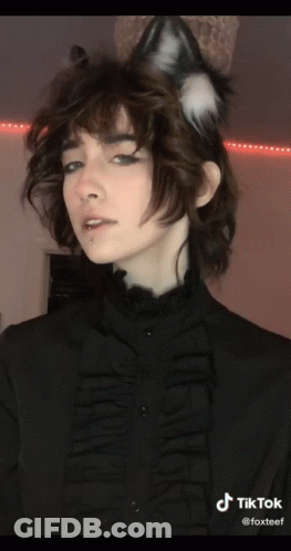 A Woman Wearing A Cat Ear Headband And A Black Shirt With Tiktok Written On The Bottom Right GIF