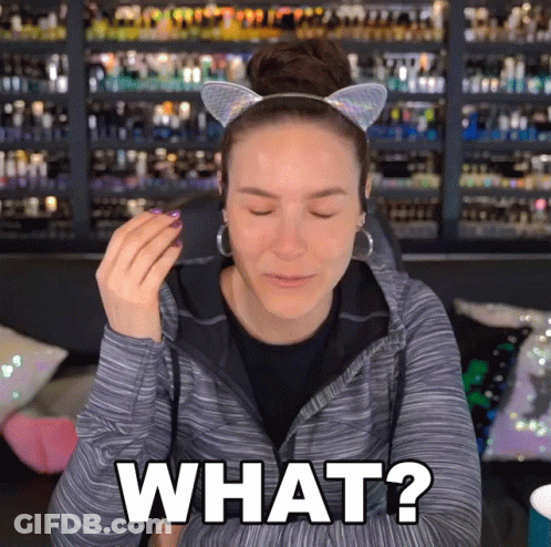 A Woman Wearing A Cat Ear Headband Is Asking What GIF