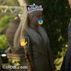 A Woman Wearing A Cat Ear Tiara With A Pacifier In Her Mouth . GIF