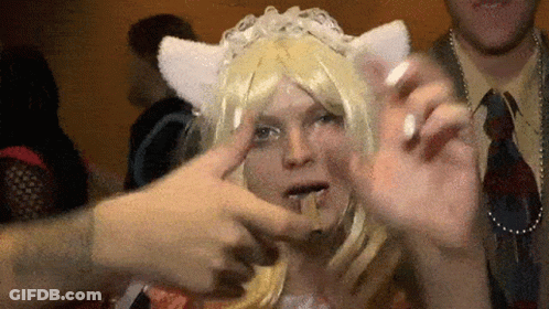 A Woman Wearing A Cat Ear Wig Is Being Touched By Someone 'S Hand GIF