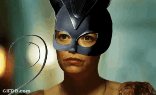 A Woman Wearing A Cat Mask Has A Swirl Around Her Neck GIF