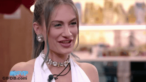 A Woman Wearing A Choker And Earrings Is Smiling With The Hashtag #Gfvip GIF