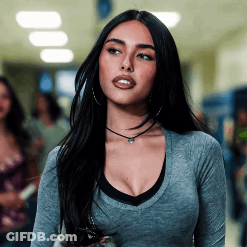 A Woman Wearing A Choker And Hoop Earrings Looks To The Side GIF