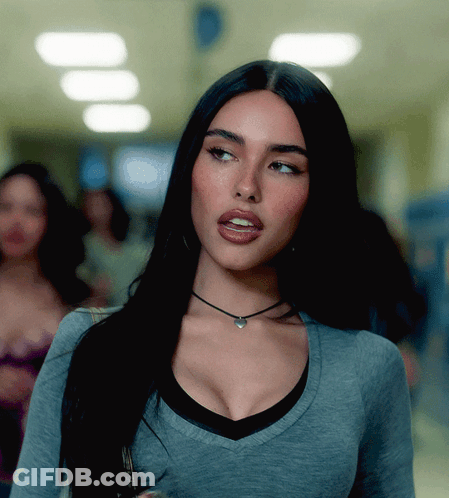 A Woman Wearing A Choker Necklace And A Gray Shirt GIF