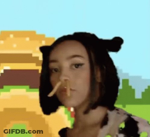 A Woman Wearing A Cow Costume Is Eating French Fries . GIF