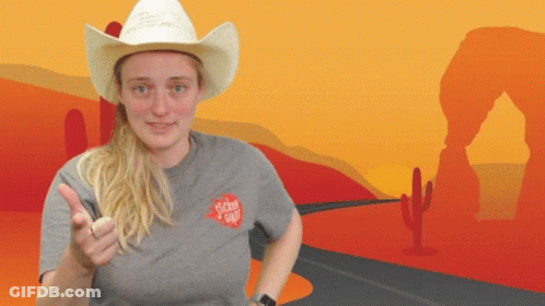 A Woman Wearing A Cowboy Hat And A Sticker Shop Shirt GIF