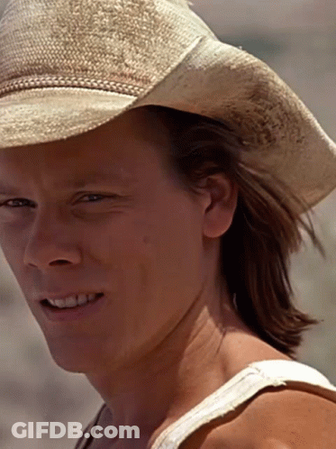 A Woman Wearing A Cowboy Hat And A White Tank Top Smiles GIF