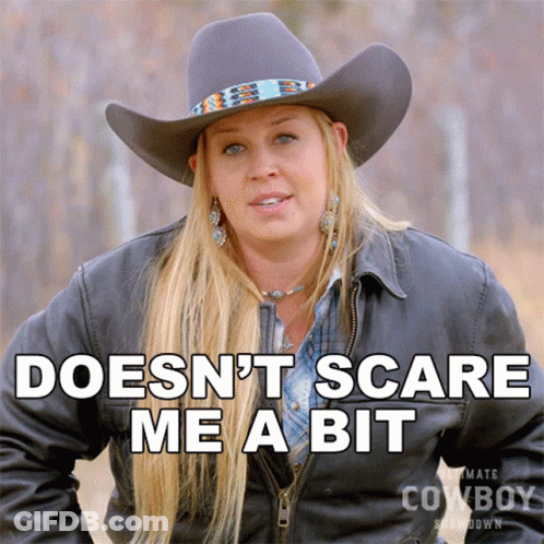 A Woman Wearing A Cowboy Hat Says " Doesn 'T Scare Me A Bit " GIF